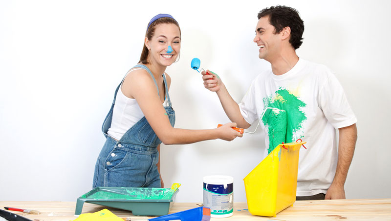 young couple playing with paint